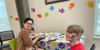Izaak Balentine gets his face painted by IndyPL staff member Marissa Cohen during the Summer Reading program kick off at the Martindale-Brightwood Branch on June 1, 2024. (Photo provided/IndyPL)