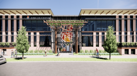 a rendering of a building with a mosaic at its interest stands over green grass 