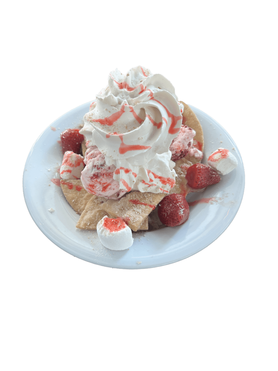 tortilla chips topped with fresh strawberry, ice cream, strawberry syrup and whipped cream