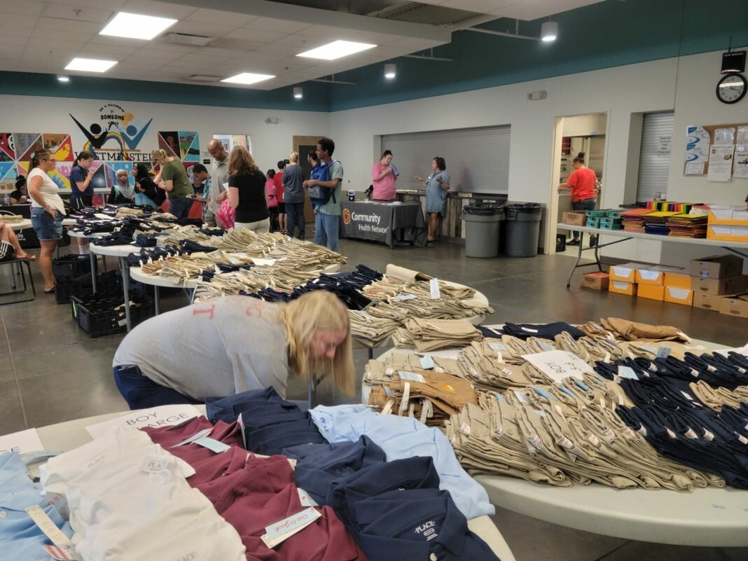 volunteers hand out t-shirts