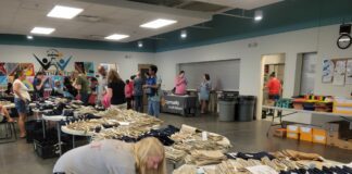 volunteers hand out t-shirts