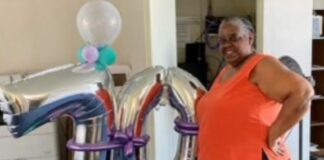 ms crystal - woman stands next to 70 balloons