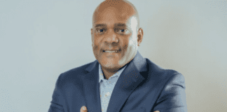 Man in a suit with arms folded.