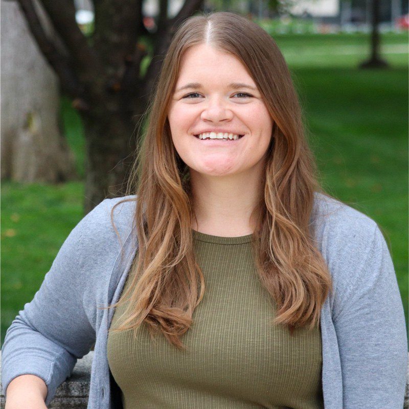 woman in green shirt and grey cardigan