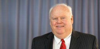 a photo of Jim Morris in a suit and tie.