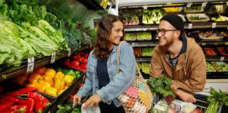 Man and woman shop for fresh fruit and vegetables