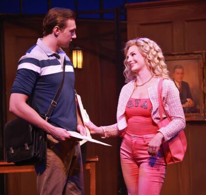 Woman in pink touches arm of man