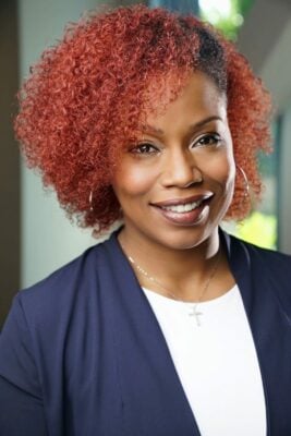 woman with red hair and blue suit