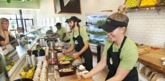 workers making food at a salad restaurant