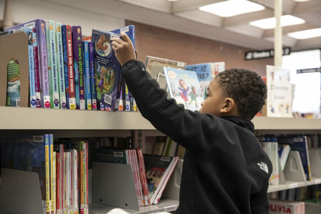 Student reaches for book