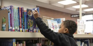 Student reaches for book