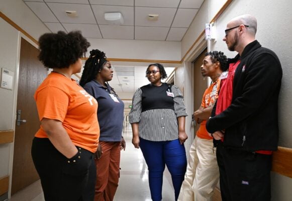 people standing in hospital hallway