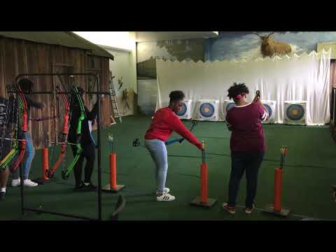 student practicing archery