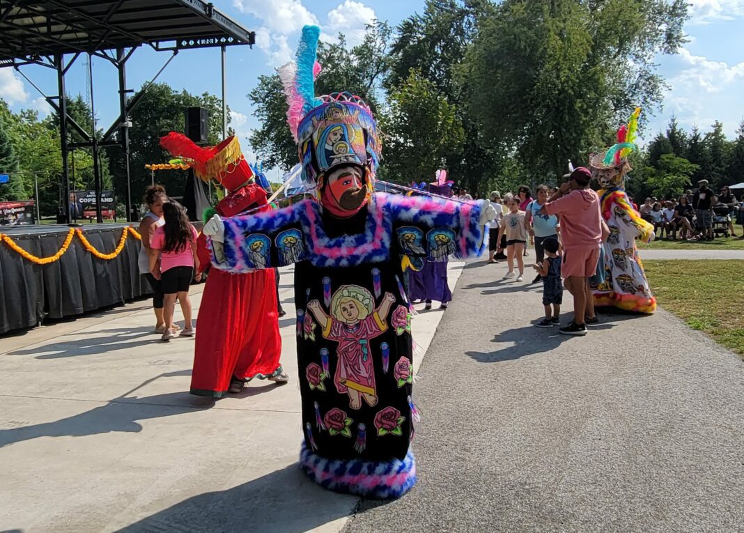 Person in traditional garb dances in park