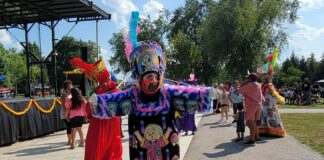 Person in traditional garb dances in park