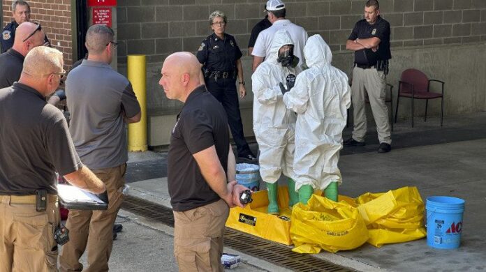 ap24261672697302 hazmat crew looks at package