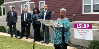 Mrs. Elizabeth Gore addresses a crowd of photographers and neighbors from Martindale Brightwood regarding the ongoing work to replace lead service lines in the neighborhood.