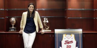 Stephanie White posing with a no. 22 Indiana Fever jersey.