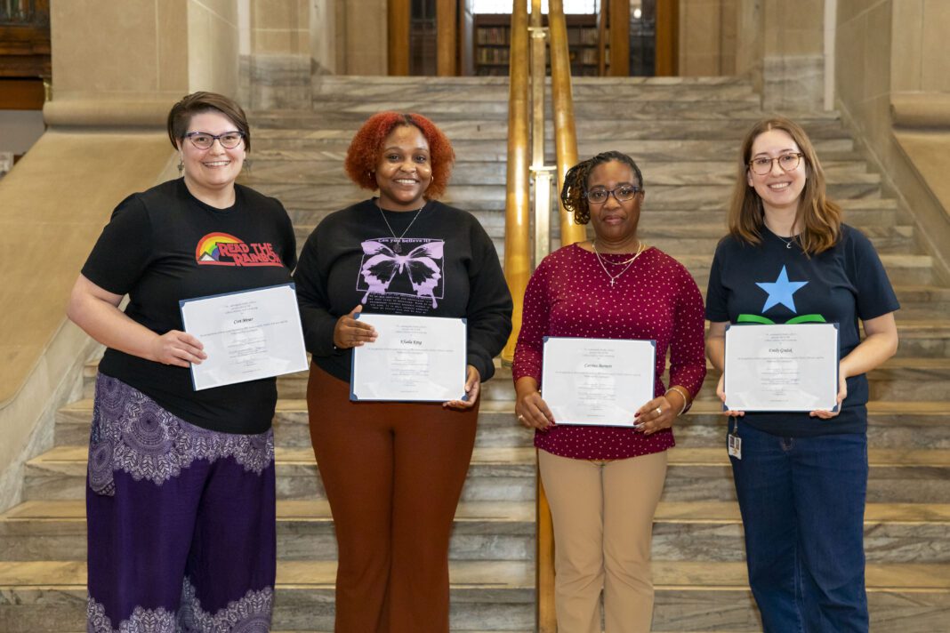 four people receiving library scholarships