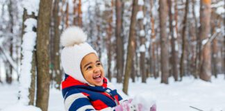 happy little girl enjoy a sleigh ride on christmas holidays.