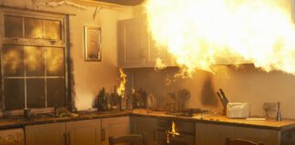 Fire raging in domestic kitchen at night