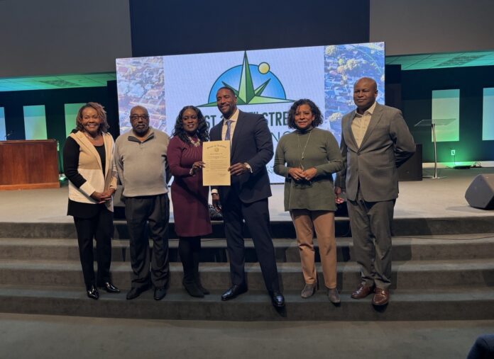 Alongside city leaders, Pastor Kenneth Sullivan Jr. of New Direction Church announced the 38th Street Renaissance Campaign in partnership with the National Bank of Indianapolis during a press conference on Dec. 11. (Photo/Chloe McGowan)