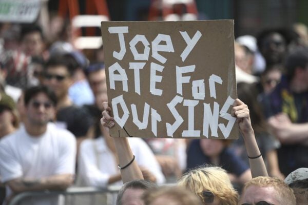Fans hold signs for Joey Chestnut 