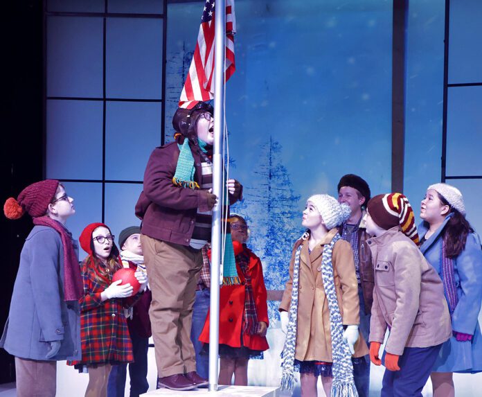 Flick (Alex Arickx) takes the “Triple Dog Dare” presented to him to stick his tongue on the school’s flagpole as the children watch in Beef & Boards Dinner Theatre’s production of A Christmas Story: The Musical, now on stage through Jan. 5.