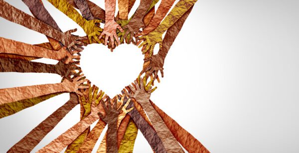 A group of people making a heart shape with their hands.