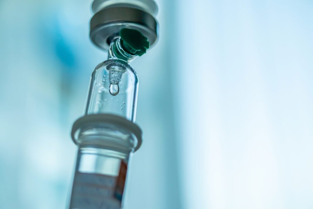 Close up medical intravenous IV drip in hospital background