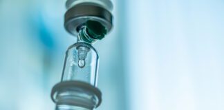 Close up medical intravenous IV drip in hospital background