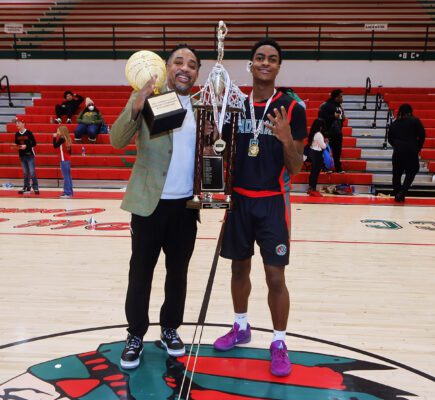 Anderson High School head basketball coach and basketball player after winning a championship game.