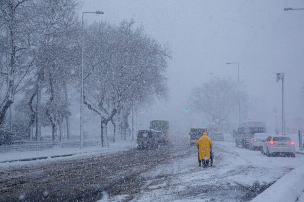front view, human walking on a snowy day