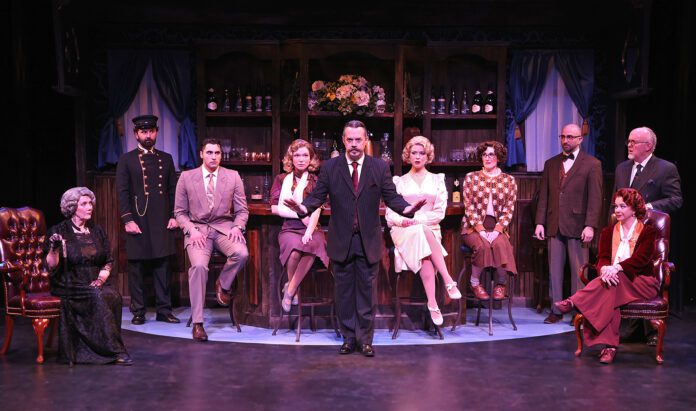 Detective Hercule Poirot (Andrew Kindig), center, reveals to the room of suspects who he believes killed Samuel Ratchett in Beef & Boards Dinner Theatre’s production of Murder on the Orient Express, now on stage. This mystery by Agatha Christie opens the 2025 Season at Beef & Boards, and is on stage through Feb. 9. For tickets and performance information, visit beefandboards.com.