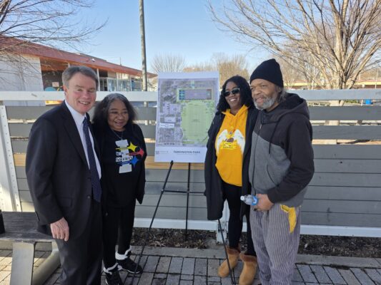 From left: Mayor of Indianapolis Joe Hogsett, mother of Coach Nell Donna Hamilton, wife of Coach Nell Tiffany Hamilton and Duane Simmons posing for a photograph in front of the anticipated plans for Tarkington Park, including the Richard 'Coach Nell' Hamilton Field, on February 25, 2025, at Tarkington Park, in Indianapolis, Indiana. (Photo/Noral Parham)