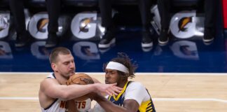 Denver Nuggets' Nikola Jokic and Indiana Pacers' Myles Turning during an NBA basketball game.