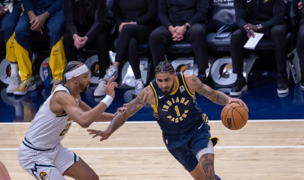 Indiana Pacers' Obi Toppin during the NBA basketball game against the Denver Nuggets attempting to drive by a defender near the paint.