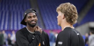 2025 NFL Scouting Combine prospects talking in between on-field drills.