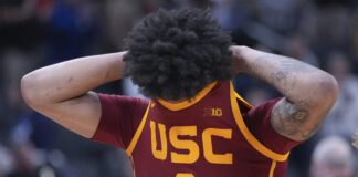 USC player hides face in jersey after losing to Purdue University in 2025 Big Ten Men's Basketball Tournament.