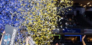 2025 Big Ten Women's Basketball Tournament Champions UCLA with confetti raining down in Gainbridge Fieldho]use after defeating USC.