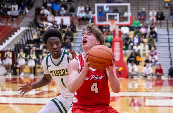 Crispus Attucks High School's Christion Hurt (1) and New Palenstine High School Moses Haynes (4) on March 22, 2025 at Southport Fieldhouse in Southport, Indiana. (Photo/Walt Thomas)
