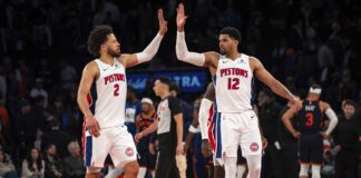 Detroit Pistons guard Cade Cunningham (2) and forward Tobias Harris (12) high-five at the end of Game 2 of an NBA basketball first-round playoff series against the New York Knicks, Monday, April 21, 2025, in New York. (AP Photo/Angelina Katsanis)