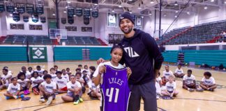 Trey Lyles and young fan during his free NBA youth basketball camp in Indianapolis, Indiana at Arsenal Technical High School in June of 2025.