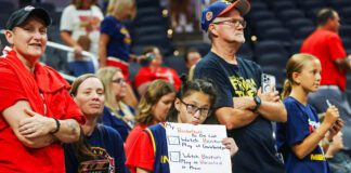 A WNBA fan almost has her checklist completed, hoping Fever forward Aliyah Boston (7) would honor her request (which she did after the game) during the WNBA game between the Los Angeles Sparks and Indiana Fever on July 5, 2025, at Gainbridge Fieldhouse in downtown Indianapolis, Indiana. (Photo/David Dixon)