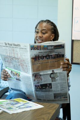 WNBA Hall of Famer Tamika Catchings reading the WNBA All-Star Edition of The Indianapolis Recorder Newspaper, on July 17, 2025, at Riverside Park, in Indianapolis, Indiana. (Photo/Mia Moore)