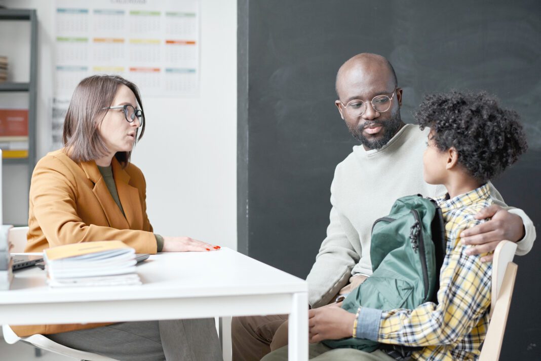 Teacher having conversation with parent