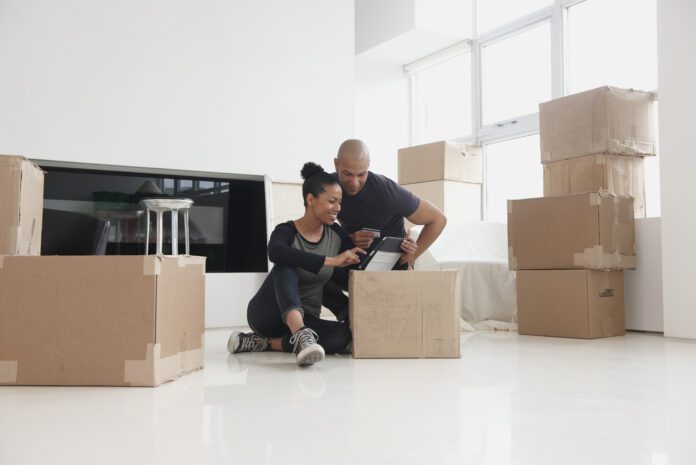 Black couple unpacking in new house