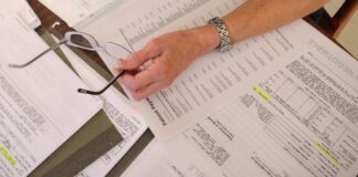 A cancer patient’s medical bills are spread on a kitchen table in a home in Salem, Va., in this 2011 file photo. A new Trump administration rule would override more than a dozen state laws that shield consumers’ credit reports from medical debt. (Photo by Don Petersen/Associated Press)