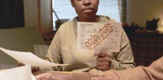 person holding a utility bill.