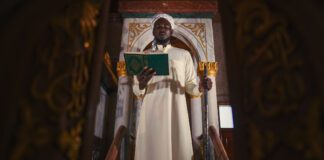 islam imam with koran book on hand making speech in isramic worship ceremony in mosque